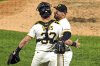 Pittsburgh Pirates pitcher David Bednar, right, celebrates with catcher Henry Davis after getting the final out of a baseball game against the Detroit Tigers in Pittsburgh, Tuesday, July 22, 2025. (AP Photo/Gene J. Puskar)