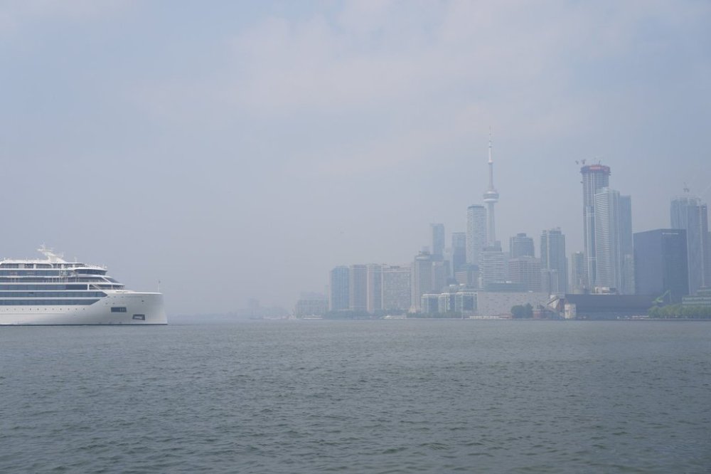 A cruise ship sits off the shore of Toronto amid air quality warnings on Monday July 14, 2025. THE CANADIAN PRESS/Chris Young