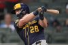 Milwaukee Brewers' Andrew Vaughn (28) hits a two-RBI single in the third inning of a baseball game against the Atlanta Braves, Tuesday, Aug. 5, 2025, in Atlanta. (AP Photo/Mike Stewart)