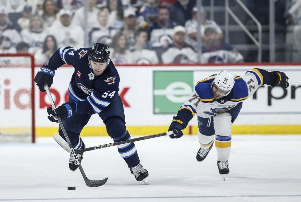 Winnipeg Jets' Dylan Samberg (54) breaks away from St. Louis Blues' Mathieu Joseph (71) during second-period NHL playoff action in Winnipeg on Saturday, April 19, 2025. THE CANADIAN PRESS/John Woods