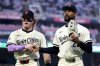 Minnesota Twins left fielder Harrison Bader, left, and center fielder Byron Buxton, right, shake hands after the sixth inning of a baseball game against the Washington Nationals, Friday, July 25, 2025, in Minneapolis. (AP Photo/Ellen Schmidt)