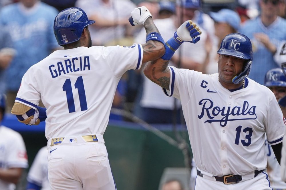 Kansas City Royals' Maikel Garcia (11) celebrates with Salvador Perez (13) after hitting a two-run home run during the fourth inning in the first baseball game of a doubleheader against the Cleveland Guardians, Saturday, July 26, 2025, in Kansas City, Mo. (AP Photo/Charlie Riedel)