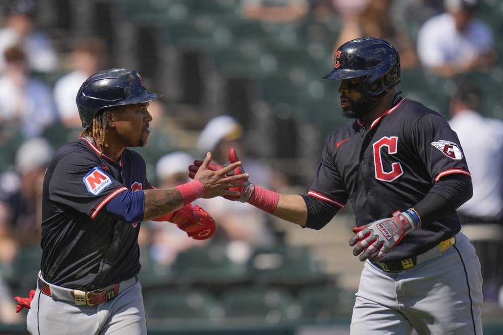 Cleveland Guardians' Carlos Santana, right, celebrates with José Ramírez, left, after hitting a two-run home run during the sixth inning of the first baseball game of a doubleheader against the Chicago White Sox, Friday, July 11, 2025, in Chicago. (AP Photo/Erin Hooley)