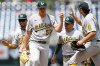 Athletics starting pitcher Jacob Lopez, waiting to be relieved, is congratulated by teammates on the mound after pitching seven and two thirds innings of shutout baseball against the Washington Nationals, Thursday, Aug. 7, 2025, in Washington. (AP Photo/John McDonnell)