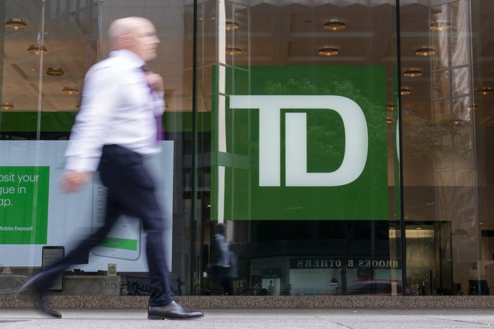 A person makes their way past a Toronto-Dominion Bank branch in Toronto, Monday, Aug. 14, 2023. THE CANADIAN PRESS/Spencer Colby
