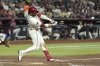 Arizona Diamondbacks' Eugenio Suárez connects for a home run against the St. Louis Cardinals during the third inning, his second of a baseball game, Sunday, July 20, 2025, in Phoenix. (AP Photo/Ross D. Franklin)