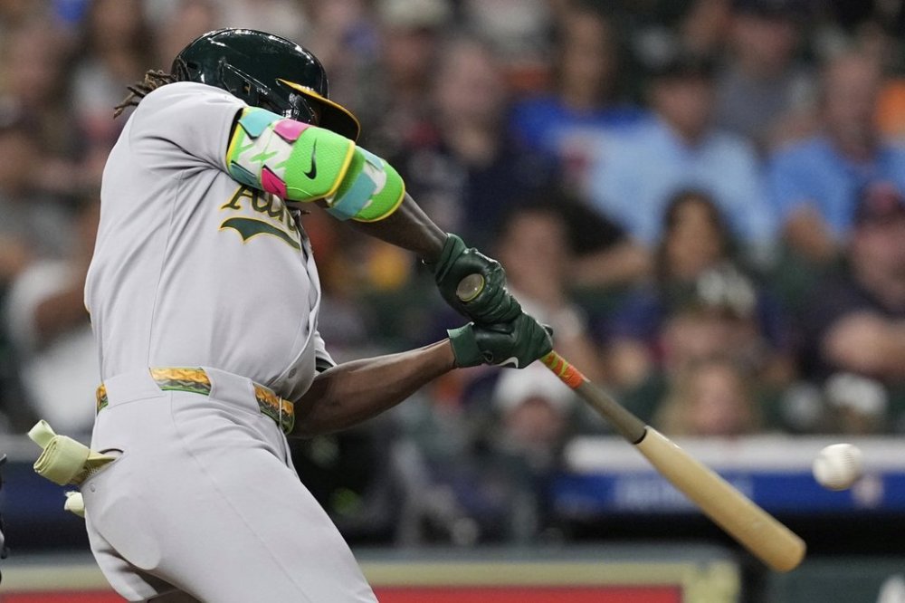 Athletics' Lawrence Butler hits a three-run home run against the Houston Astros during the ninth inning of a baseball game Saturday, July 26, 2025, in Houston. (AP Photo/David J. Phillip)