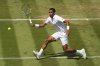 Felix Auger‑Aliassime of Canada returns the ball to Jan-Lennard Struff of Germany during their second round men's singles match at the Wimbledon Tennis Championships in London, Thursday, July 3, 2025. (AP Photo/Kirsty Wigglesworth)