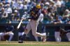 Milwaukee Brewers' Brice Turang hits a two-run double during the seventh inning of a baseball game against the Seattle Mariners, Wednesday, July 23, 2025, in Seattle. (AP Photo/John Froschauer)