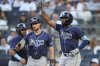 Tampa Bay Rays' Junior Caminero, right, celebrates with teammates Josh Lowe and Jonathan Aranda, left, after hitting a two-run home run during the first inning of a baseball game against the New York Yankeesv Monday, July 28, 2025, in New York. (AP Photo/Frank Franklin II)