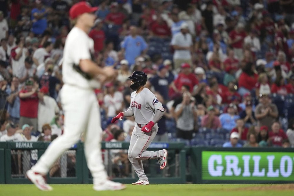 Boston Red Sox's Carlos Narváez, right, rounds the bases after hitting a go-ahead two-run home run against Philadelphia Phillies pitcher Seth Johnson during the 11th inning of a baseball game Wednesday, July 23, 2025, in Philadelphia. (AP Photo/Matt Slocum)