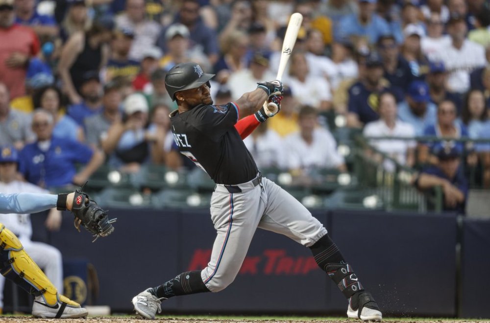 Miami Marlins' Otto Lopez hits a three-run double during the seventh inning of a baseball game against the Milwaukee Brewers, Friday, July 25, 2025, in Milwaukee. (AP Photo/Jeffrey Phelps)