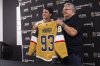 Newly acquired Golden Knights forward Mitch Marner, left, poses for a photo with his jersey alongside Golden Knights general manager Kelly McCrimmon at City National Arena on Tuesday, July 1, 2025, in Las Vegas. (Chase Stevens/Las Vegas Review-Journal via AP)