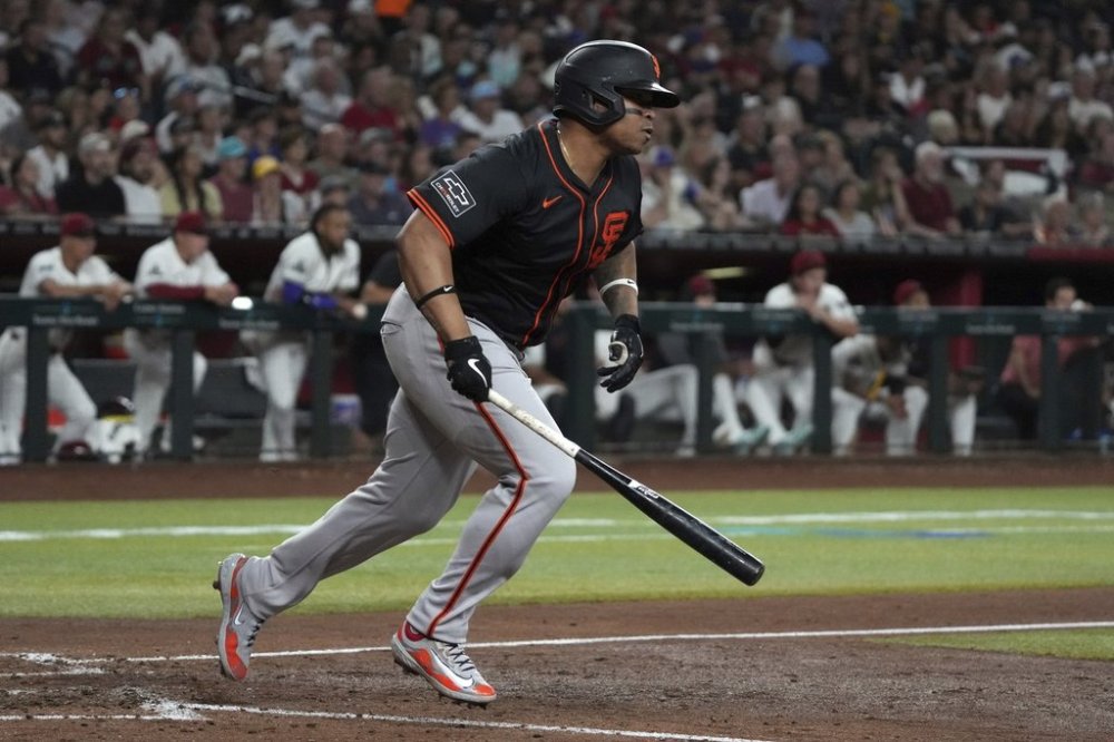 San Francisco Giants' Rafael Devers starts to run after hitting a two-run single against the Arizona Diamondbacks in the seventh inning during a baseball game, Thursday, July 3, 2025, in Phoenix. (AP Photo/Rick Scuteri)