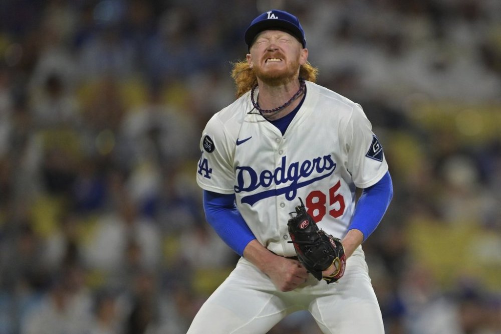 Los Angeles Dodgers starting pitcher Dustin May reacts after giving up a single to Minnesota Twins' Matt Wallner during the eighth inning of a baseball game Monday, July 21, 2025, in Los Angeles. (AP Photo/Jayne Kamin-Oncea)