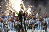 FILE — Argentina's Lionel Messi lifts the trophy after winning the World Cup final soccer match between Argentina and France at the Lusail Stadium in Lusail, Qatar, Sunday, Dec. 18, 2022. The World Cup group stage format for 2026 was changed to 12 groups of four teams from 16 groups of three teams by FIFA’s Council on Tuesday, March 14, 2023. (AP Photo/Martin Meissner, File)