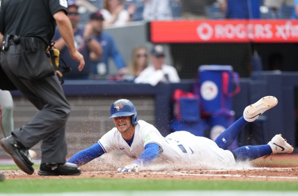 Toronto Blue Jays third base Ernie Clement (22) is safe a home plate during sixth inning MLB action against the San Francisco Giants in Toronto on Saturday, July 19, 2025. THE CANADIAN PRESS/Nathan Denette