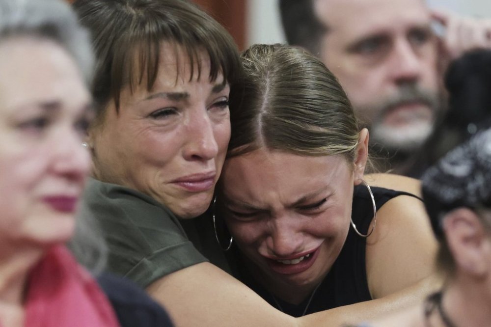 Dylan Mortensen gets a hug after speaking at the sentencing hearing of Bryan Kohberger at the Ada County Courthouse, for his sentencing hearing, Wednesday, July 23, 2025, in Boise, Idaho, for brutally stabbing four University of Idaho students to death nearly three years ago. (AP Photo/Kyle Green, Pool)