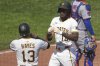 Pittsburgh Pirates' Oneil Cruz, center, celebrates with Ke'Bryan Hayes (13) after both scored on his two-run home run off New York Mets pitcher Dedniel Núñez during the seventh inning of a baseball game in Pittsburgh, Sunday, June 29, 2025. (AP Photo/Gene J. Puskar)