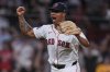 Boston Red Sox pitcher Brayan Bello celebrates after getting the win, throwing a complete game against the Colorado Rockies after a baseball game at Fenway Park, Tuesday, July 8, 2025, in Boston. (AP Photo/Charles Krupa)