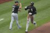 Chicago White Sox's Luis Robert Jr., right, is greeted by third base coach Justin Jirschele (17) as he rounds third after hitting a solo home run off Pittsburgh Pirates pitcher Bailey Falter during the fourth inning of a baseball game in Pittsburgh, Friday, July 18, 2025. (AP Photo/Gene J. Puskar)