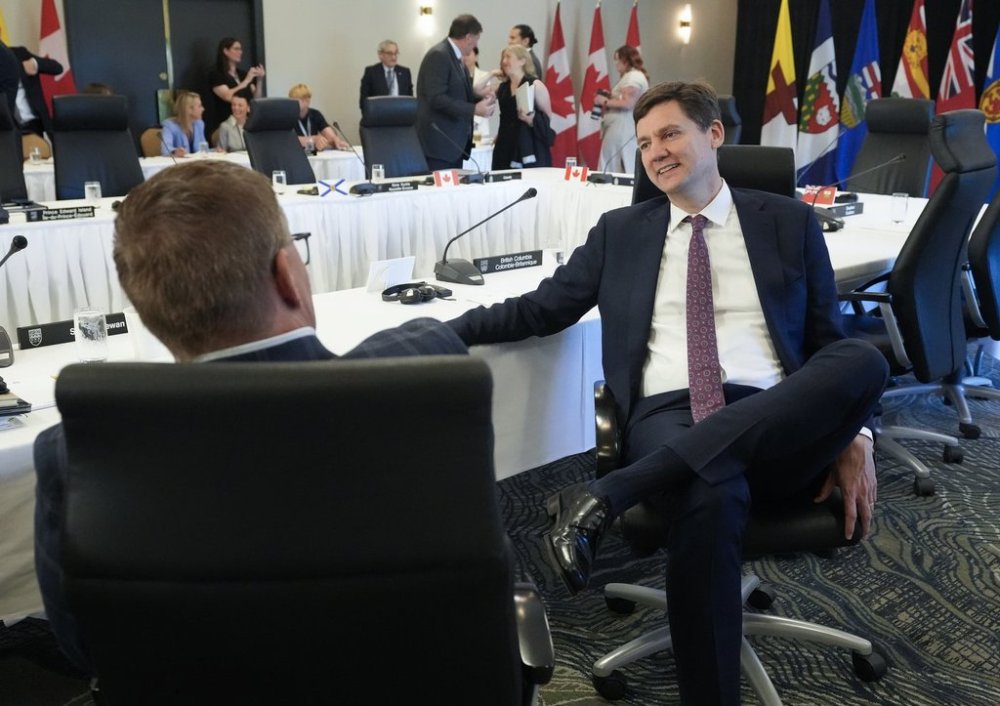 British Columbia Premier David Eby, right, talks with Saskatchewan Premier Scott Moe during the meetings of Canada’s premiers in Huntsville, Ont., on Tuesday, July 22, 2025. THE CANADIAN PRESS/Nathan Denette