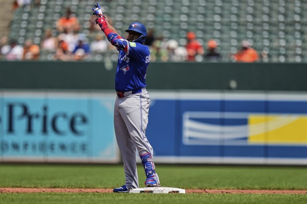 Toronto Blue Jays first baseman Vladimir Guerrero Jr. celebrates after hitting a double during the third inning of a baseball game against the Baltimore Orioles, Wednesday, July 30, 2025, in Baltimore. (AP Photo/Stephanie Scarbrough)