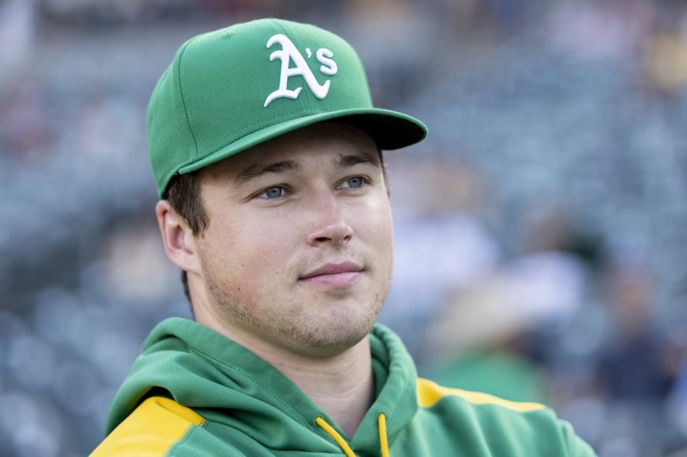 Athletics pitcher Mason Miller looks to the field before a baseball game against the Toronto Blue Jays, Friday, July 11, 2025, in West Sacramento, Calif. (AP Photo/Sara Nevis)