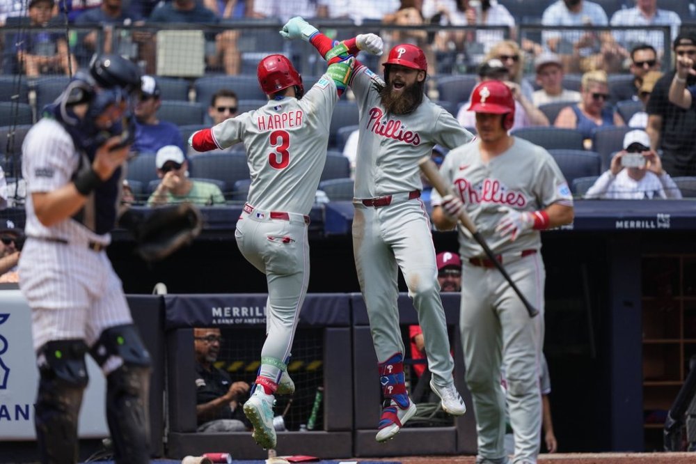 Philadelphia Phillies' Bryce Harper (3) and' Brandon Marsh (16) celebrate after Harper hit a home run during the third inning of a baseball game against the New York Yankees, Saturday, July 26, 2025, in New York. (AP Photo/Yuki Iwamura)