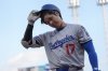 Los Angeles Dodgers' Shohei Ohtani walks to the dugout after striking out during the first inning of a baseball game against the Cincinnati Reds, Tuesday, July 29, 2025, in Cincinnati. (AP Photo/Carolyn Kaster)