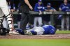 Toronto Blue Jays' George Springer lies on the ground after being hit by a pitch by Baltimore Orioles reliever Kade Strowd during the ninth inning of a baseball game, Monday, July 28, 2025, in Baltimore. (AP Photo/Stephanie Scarbrough)