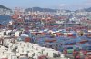 Cranes and shipping containers are seen at a port in Busan, South Korea, Thursday, July 31, 2025. (Gang Seon-bae/Yonhap via AP)