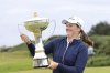 England's Lottie Woad holds the trophy after winning the Women's Scottish Open at the Dundonald Links, Irvine, Scotland, Sunday July 27, 2025. (Steve Welsh/PA via AP)