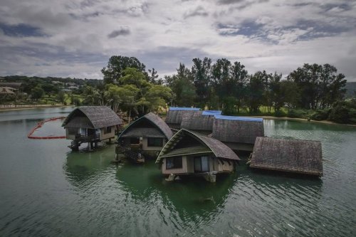 The once iconic Holiday Inn villas in Port Vila, Vanuatu, Saturday, July 19, 2025, sit partially sunken after being hit by multiple cyclones and an earthquake that caused irreparable damage. (AP Photo/Annika Hammerschlag)