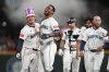 Seattle Mariners' Cole Young, left, celebrates with Julio Rodriguez, second from left, after hitting a game-winning single against the Houston Astros in the 11th inning of a baseball game Saturday, July 19, 2025, in Seattle. (AP Photo/Lindsey Wasson)