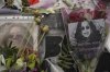 Flowers and messages are left by fans to commemorate the death of Ozzy Osbourne at the Black Sabbath Bridge in Birmingham, Wednesday, July 23, 2025. (AP Photo/Kin Cheung)