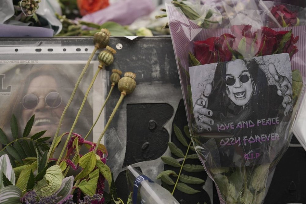 Flowers and messages are left by fans to commemorate the death of Ozzy Osbourne at the Black Sabbath Bridge in Birmingham, Wednesday, July 23, 2025. (AP Photo/Kin Cheung)