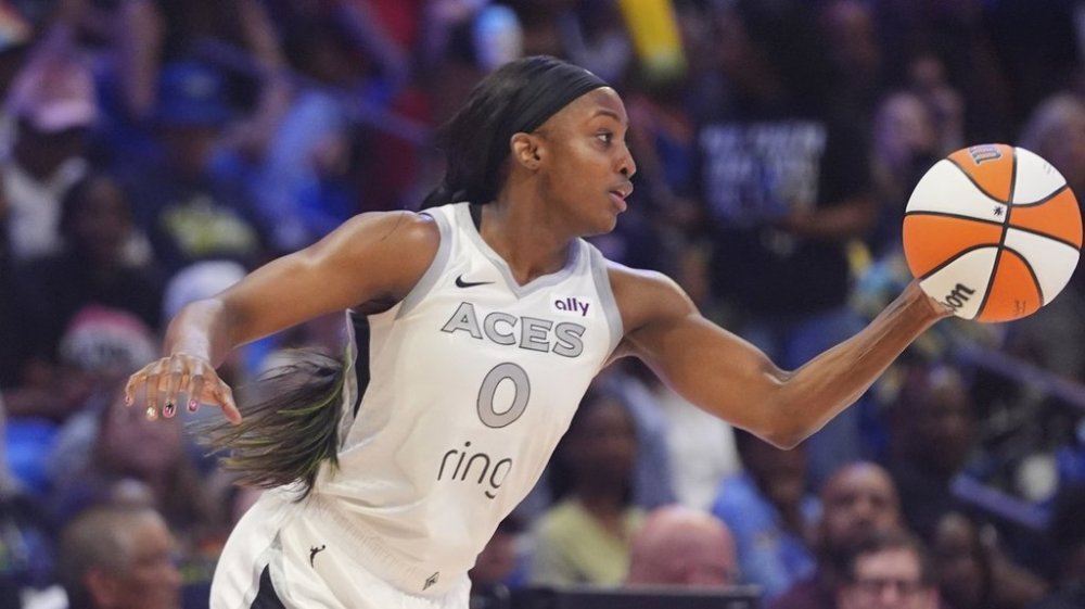 Las Vegas Aces guard Jackie Young takes control of the ball during the first half of a WNBA basketball game against the Dallas Wings in Arlington, Texas, Sunday, July 27, 2025. (AP Photo/LM Otero)