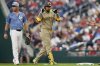 San Diego Padres' Luis Arraez (4) gestures after hitting a single against the Washington Nationals during the third inning of a baseball game at Nationals Park, Friday, July 18, 2025, in Washington. (AP Photo/Jess Rapfogel)
