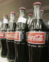 FILE - Bottles of Mexican Coca-Cola fill a prominent spot on the shelves of the Tarascas Latino Supermarket in Lawrenceville, Ga., Nov. 3, 2004. (AP Photo/RicFeld, File)