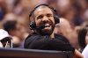 Rapper Drake has a laugh during first half NBA basketball action between the Golden State Warriors and Toronto Raptors in Toronto on Wednesday, November 16, 2016. THE CANADIAN PRESS/Frank Gunn