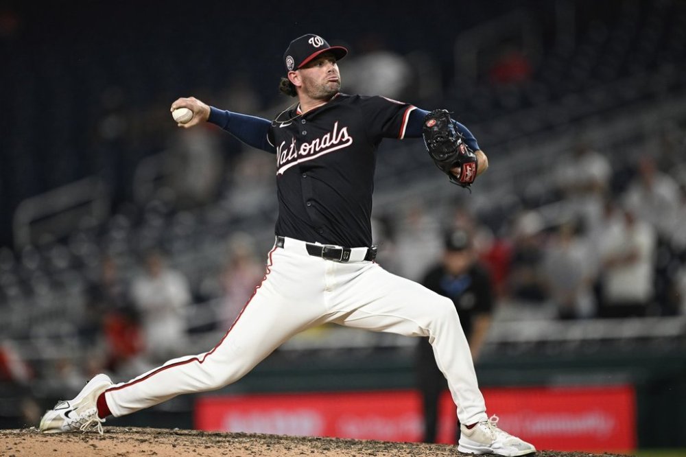 Washington Nationals pitcher Kyle Finnegan throws during the ninth inning of a baseball game against the Cincinnati Reds in Washington, Monday, July 21, 2025. (AP Photo/Terrance Williams)