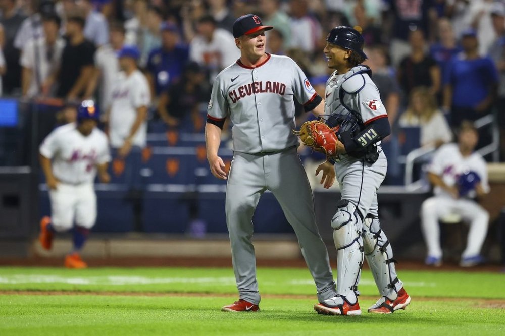 Cleveland Guardians pitcher Nic Enright, left, and catcher Bo Naylor, right, celebrate after their win in a baseball game against the New York Mets at Citi Field in New York, Monday, Aug. 4, 2025. (Gordon Donovan via AP)