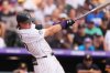 Colorado Rockies' Jordan Beck follows through with his swing after connecting for a three-run home run off Pittsburgh Pirates starting pitcher Paul Skenes in the sixth inning of a baseball game Saturday, Aug. 2, 2025, in Denver. (AP Photo/David Zalubowski)