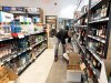An employee removes American spirits from an SAQ liquor store in Montreal on Tuesday, March 4, 2025. THE CANADIAN PRESS/Christinne Muschi