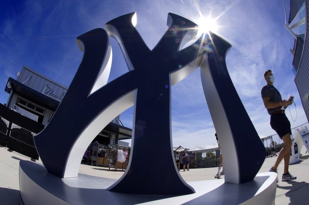 FILE - A giant New York Yankee logo greets baseball fans inside George M. Steinbrenner Field before a spring training exhibition baseball game between the New York Yankees and the Detroit Tigers in Tampa, Fla., Friday, March 5, 2021. (AP Photo/Gene J. Puskar, File)