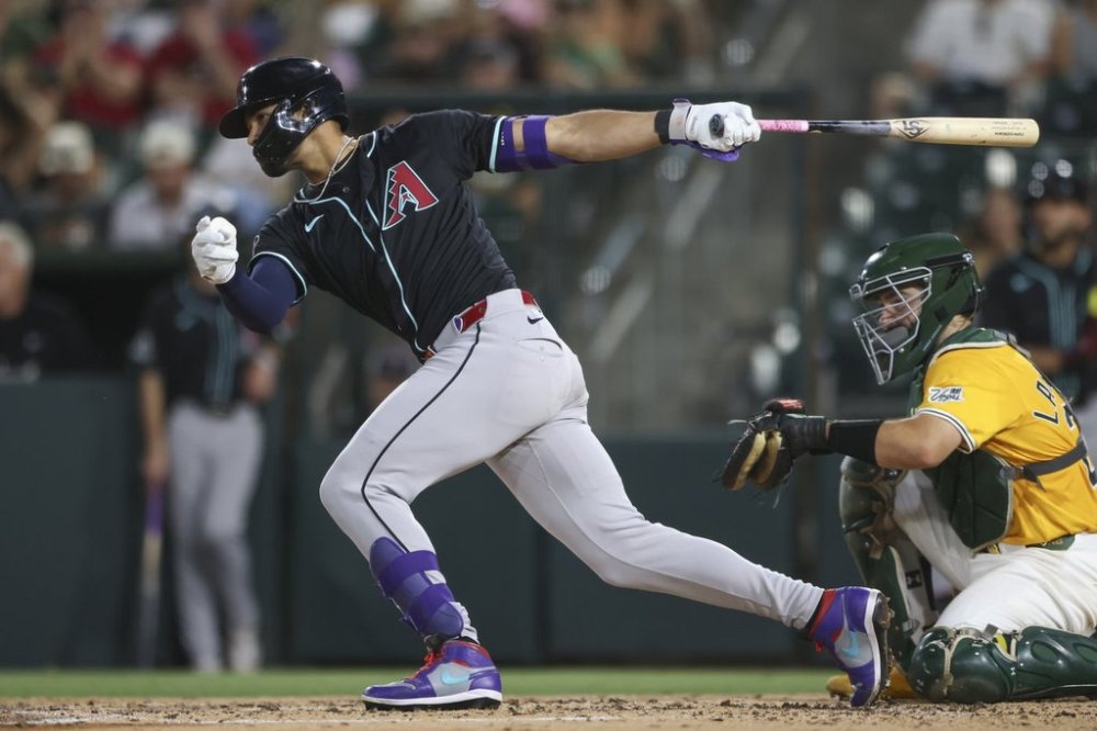 Arizona Diamondbacks' Lourdes Gurriel Jr. hits a single that scores a two runs during the fifth inning of a baseball game against the Athletics, Saturday, Aug. 2, 2025, in West Sacramento, Calif. (AP Photo/Scott Marshall)