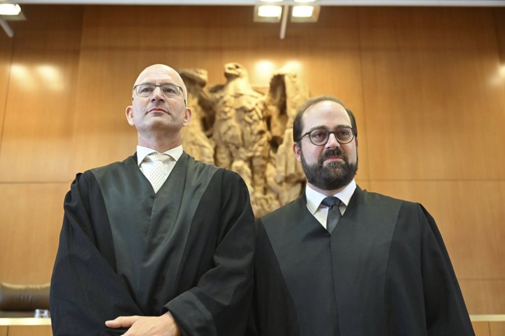 Andreas Schueller, right, and Soenke Hilbrans, lawyers representing the complainants in the proceedings concerning U.S. drone missions via Ramstein, wait in the Federal Constitutional Court for the verdict to be announced, in Karlsruhe, Germany, Tuesday July 15, 2025. (Uli Deck/dpa via AP)