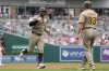 San Diego Padres designated hitter Xander Bogaerts, left, celebrates his grand slam with third base coach Tim Leiper (33) as he runs the bases during the first inning of a baseball game against the Washington Nationals at Nationals Park, Sunday, July 20, 2025, in Washington. (AP Photo/Jess Rapfogel)