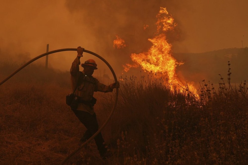 A firefighter battles the Canyon Fire on Thursday, Aug. 7, 2025, in Halsey Canyon, Calif. (AP Photo/Marcio Jose Sanchez)